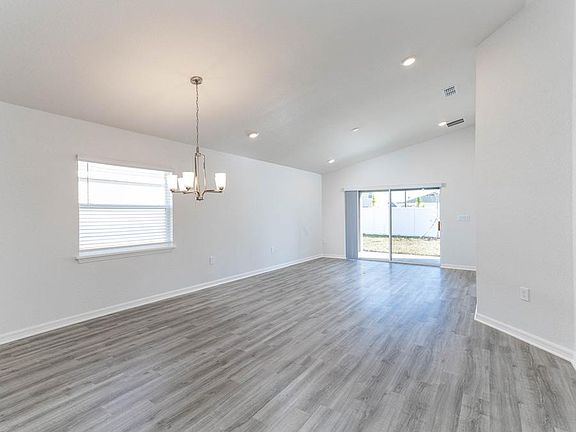 Enjoy an open living area with airy volume ceilings and luxe, low-maintenance vinyl plank flooring -