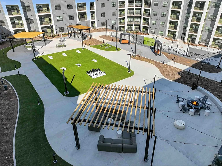 Enjoy evenings by the fire pits, friendly competition on the putting green, lawn games and chess, or unwind in Adirondack chairs and hammocks beneath the open sky.