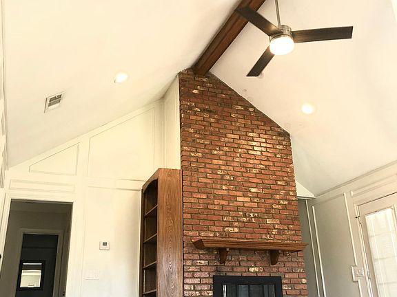 living room with 18 foot vaulted ceiling & gas log fireplace