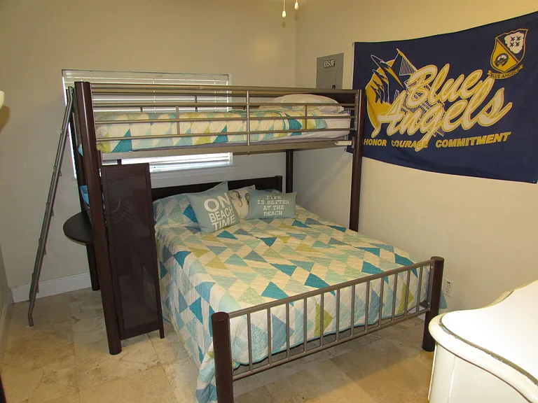 Second bedroom with full size below and twin above along with closet and chest-of-drawers.
