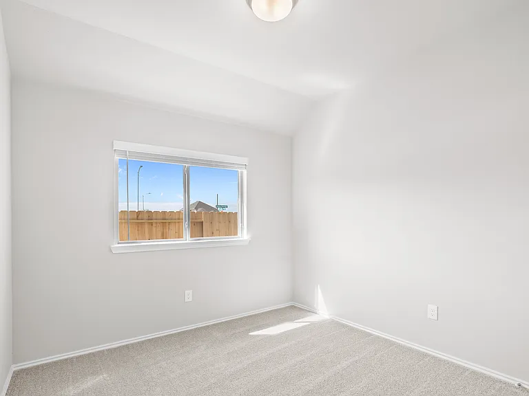 Bright secondary bedroom with carpet and large window a?? ideal as a guest room or home office.