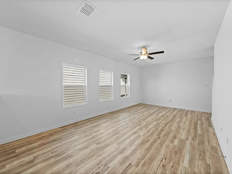 Large family room with three windows.