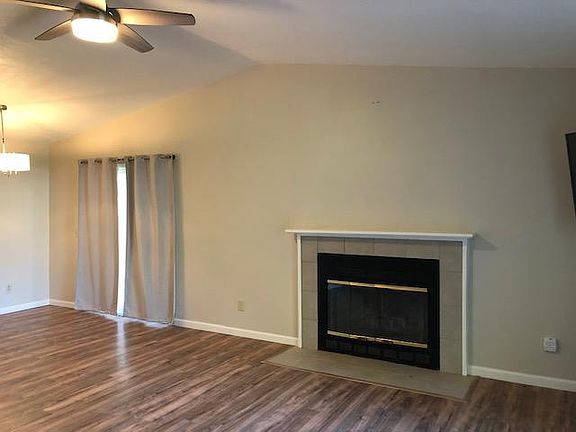 Living room attached to dining area on left. Slider to back deck on right.