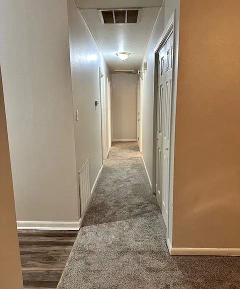 View down hallway to bedrooms from dining room.