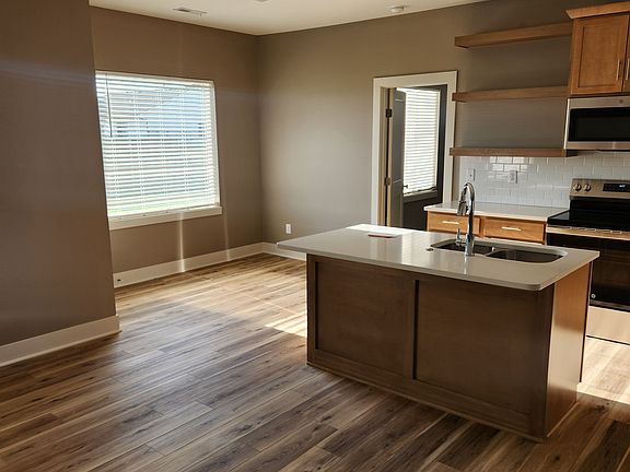 view from living room towards kitchen and dining area