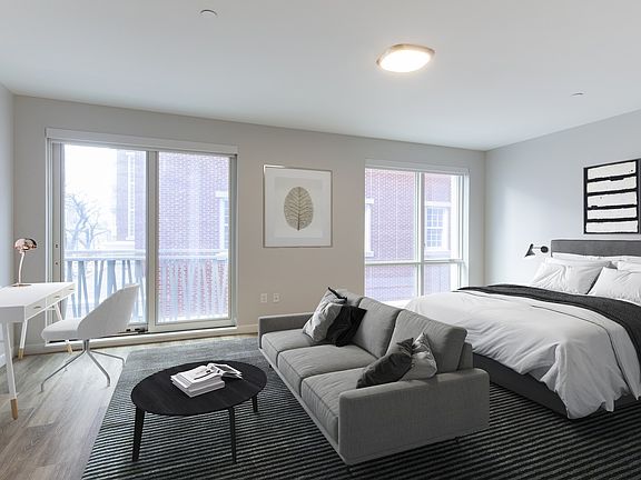 Spacious studio apartments with large windows for natural light