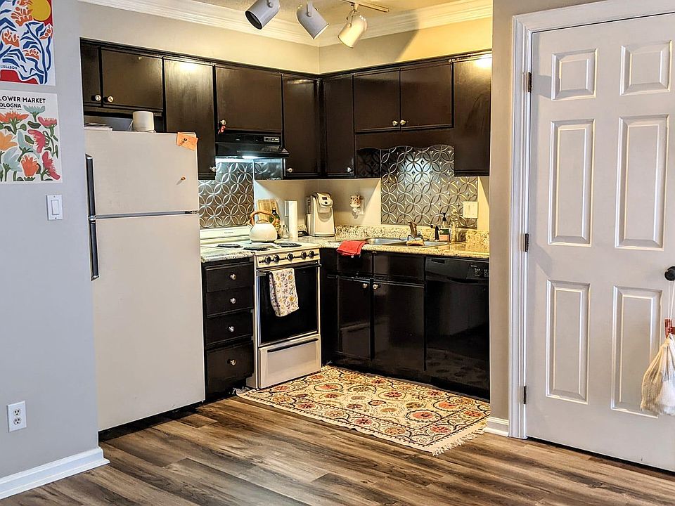 Kitchen with freshly painted cabinets. Washer/dryer closet to the right.