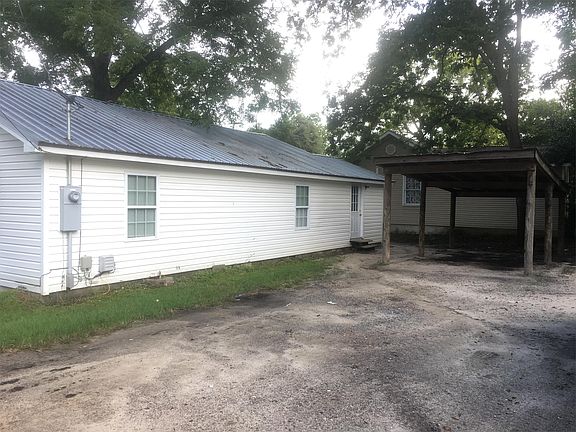 Back of house with carport area