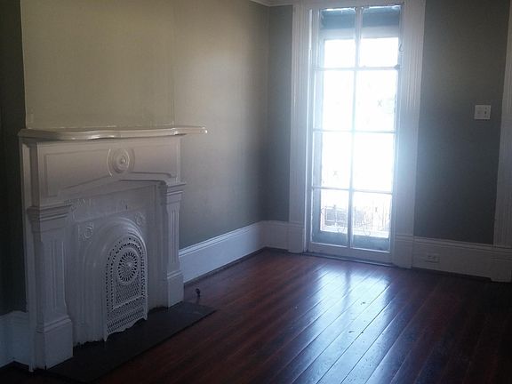 Mantle and window in front room. This room has 12' ceiling and a beautiful plaster medallion, with pocket doors separating from next room.