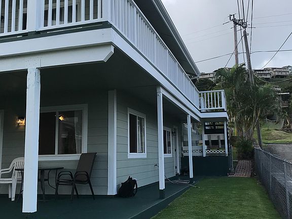 Front entrance is to the left under the stairs