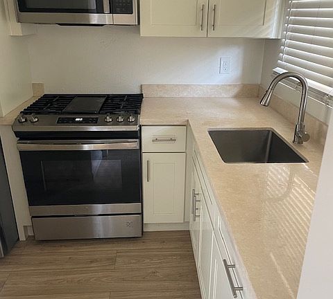 kitchen w new cabinets, counters and appliances