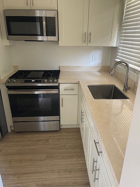 kitchen w new cabinets, counters and appliances