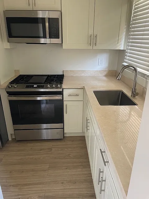 kitchen w new cabinets, counters and appliances