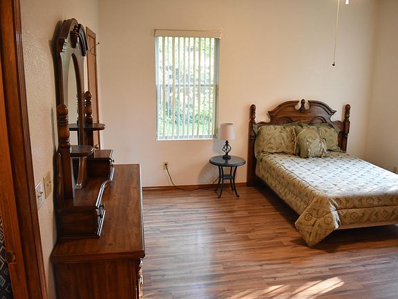 Full size bed, hard floors, large room with 2 dressers, 2 windows, walk in closet