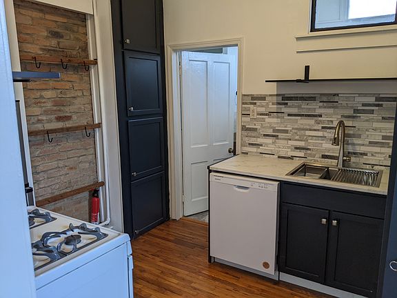 Newly remodeled kitchen has gas range, new fridge, new dishwasher, new countertop, sink and sink base. Lots of cabinet, pantry, and shelf space, newly marbled backsplashes at sink and range.