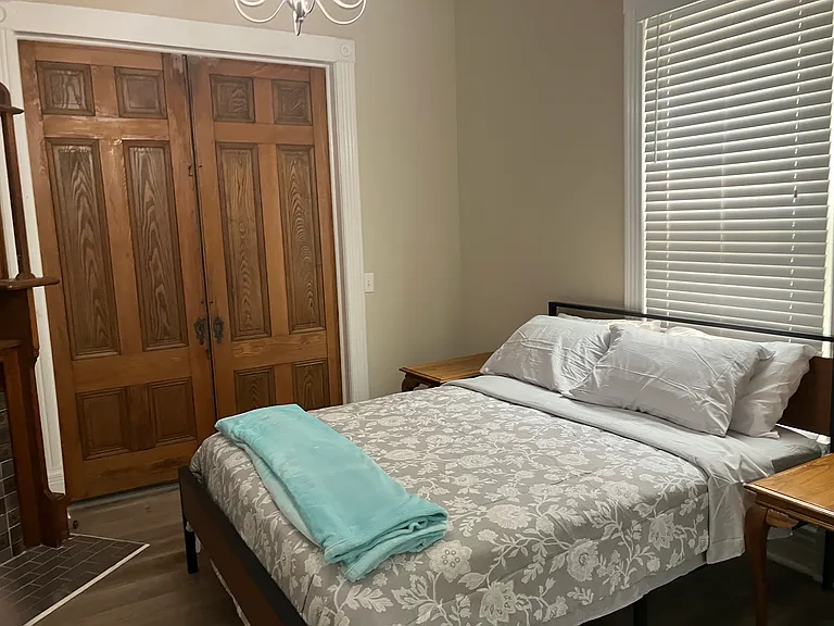 Large, fully furnished first bedroom that can serve as an office or den.