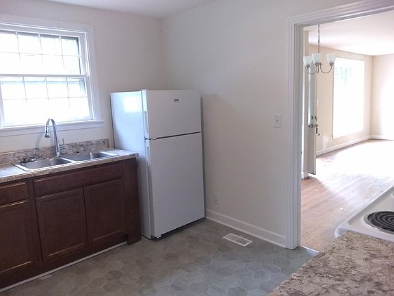 New Kitchen Cabinets, floors and tops in this cozy galley kitchen.