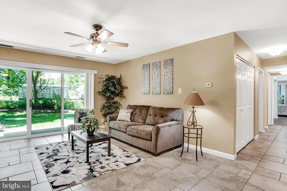 Living room with sliders leading to patio. - 2572 Riva Rd #5B