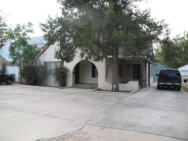 Front exterior of house. Notice the paved offstreet parking for 4 cars