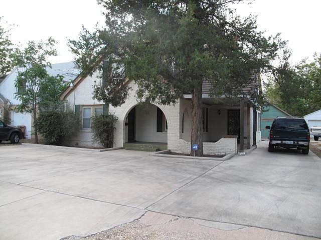 Front exterior of house. Notice the paved offstreet parking for 4 cars