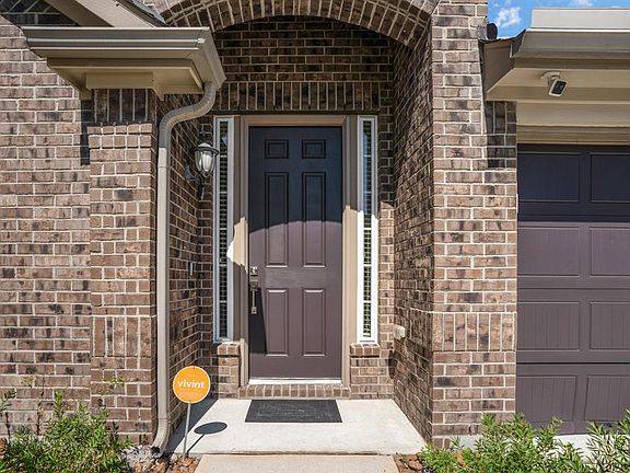 The home welcomes you with a solid front door and dual wide driveway.