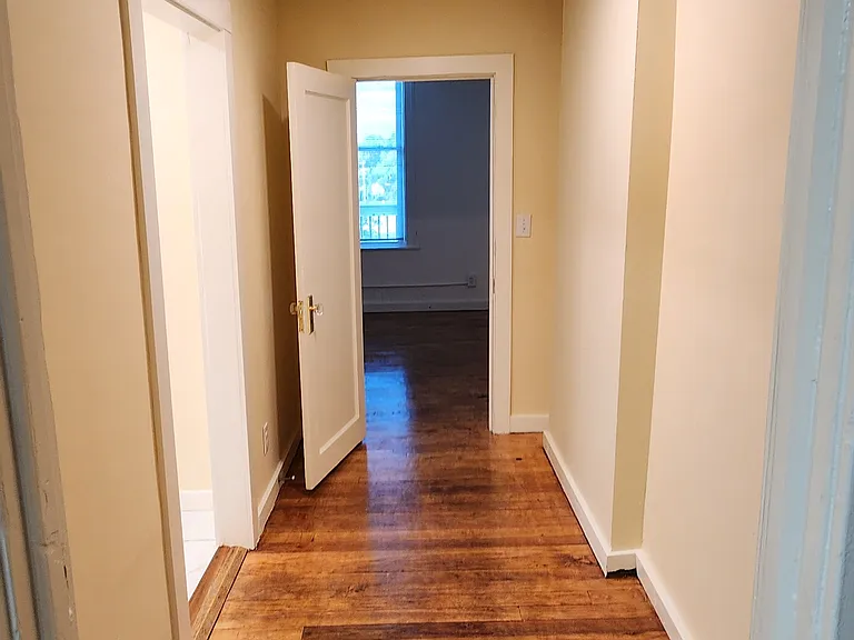 Hall from kitchen to 2nd bath, laundry 3rd bedroom, and access to balcony deck