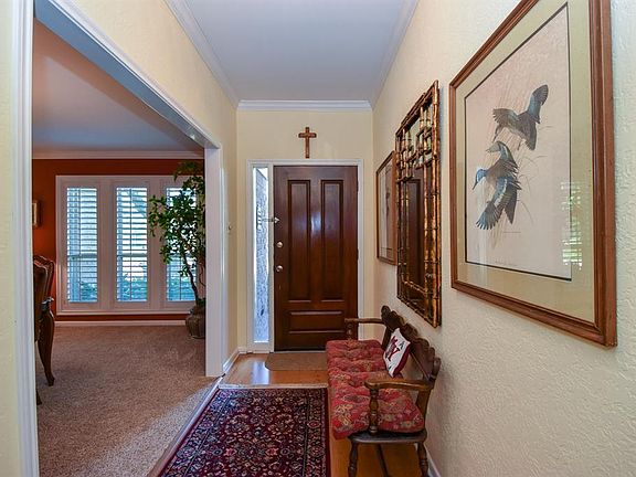 Solid wood front door welcomes you to a spacious foyer and generous size dining room overlooking a manicured front yard.