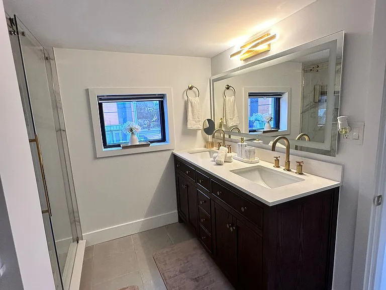 Stylish cabinets and drawers with clean towel set provided.