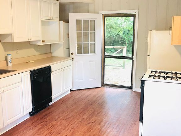 Spacious kitchen with 2 pantries, custom cabinets, all appliances-leads to great deck