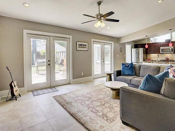 Great family room with double French doors leading to the back yard. The heart of the home is this raised ceiling and tiled space that opens to the breakfast bar and kitchen.