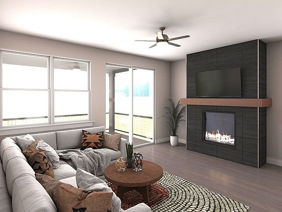 The living room has a gas fireplace and covered deck access