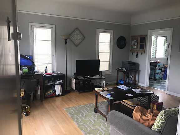 Living room and kitchen doorway. High ceilings and crown moldings.