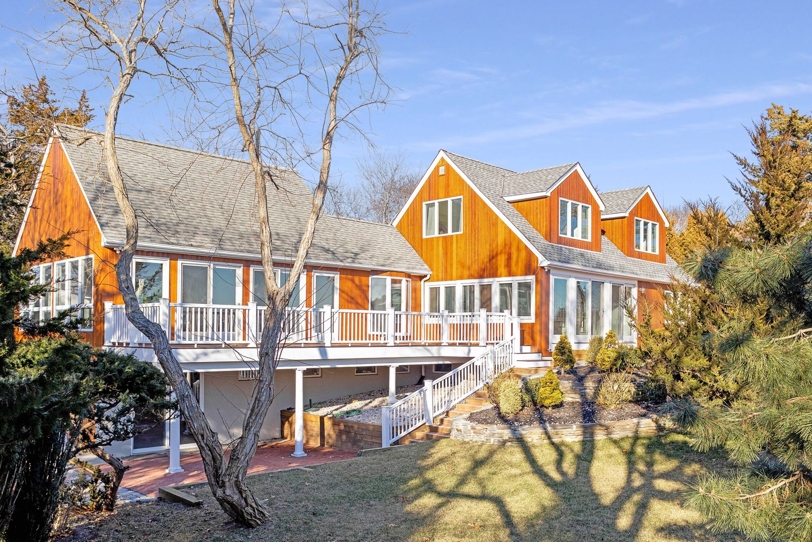  Rear view of house with a lawn and a wooden deck