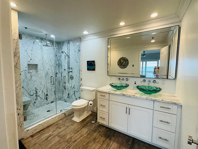 Fully remodeled master bath. Adjacent is the walk-in closet with built-in shelves.