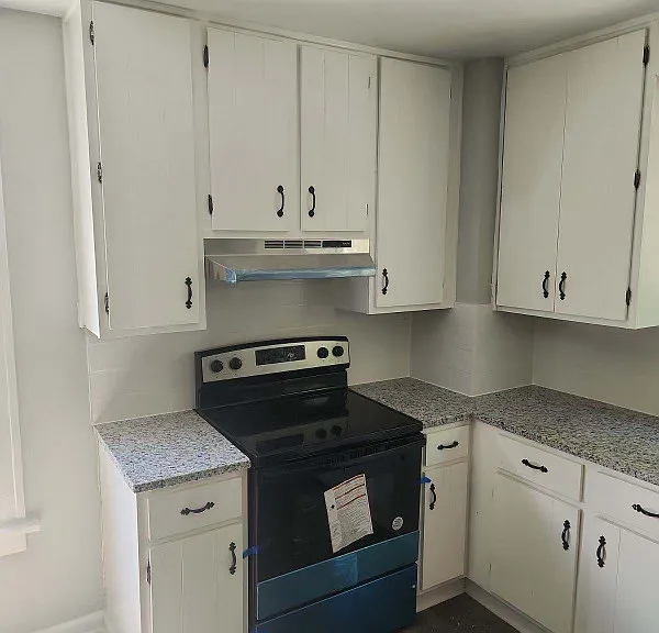 Kitchen with no-slam cabinets, stainless steel appliances, and granite counters