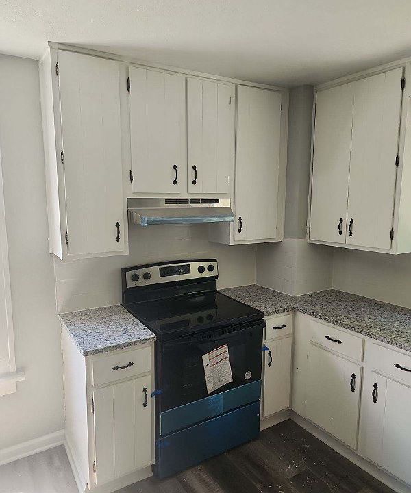 Kitchen with no-slam cabinets, stainless steel appliances, and granite counters