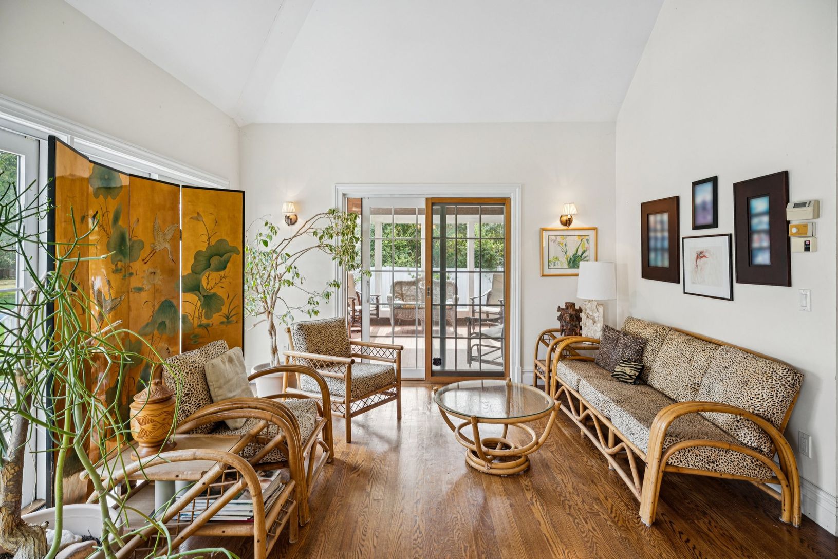 Inviting living area showcasing rich wood-finished floors and a soaring cathedral ceiling.