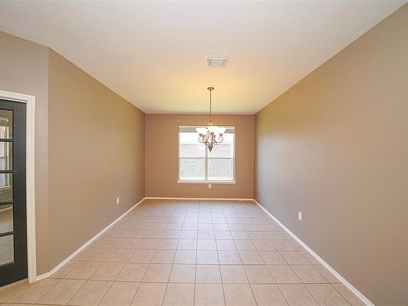 Generously sized formal dining room with chandelier , tile flooring and a large window, will accommodate a good size table for those special family gatherings !