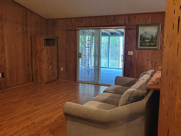 Living room, sliding glass doors open to large back porch