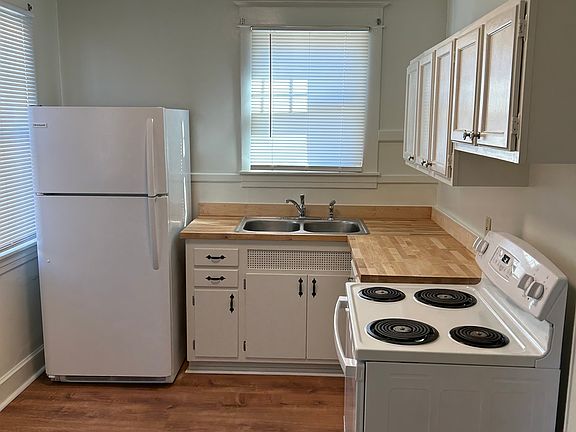 Kitchen w/new countertops, sink, faucet, and flooring, newer stove