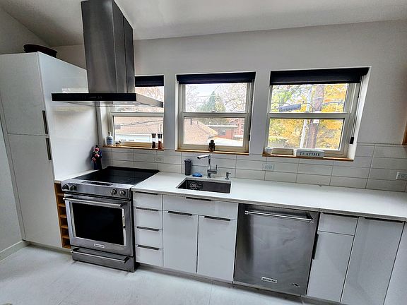 Kitchen: Kitchenaide appliances, pantry to the left with microwave.