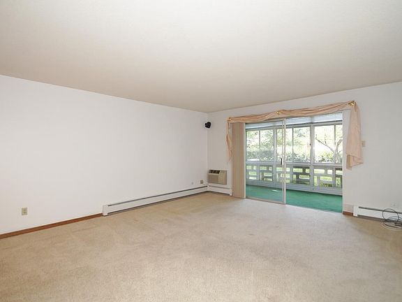 The living room opens to a glass Lanai to provide some outdoor space.
