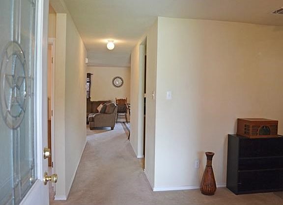 Looking through the front entry way, the formal living area is to the right, the living/family room is straight ahead, and the hallway which leads to the guest wing is to the left.