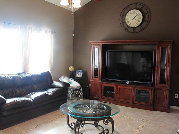 Family room has a wall of windows overlooking the back yard.