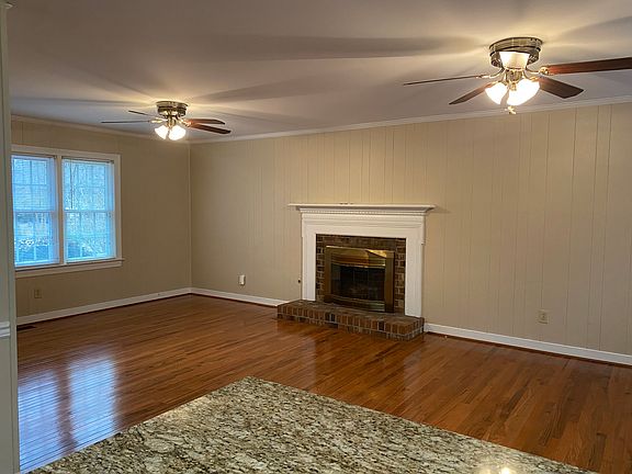 Den with gas fireplace from kitchen.
