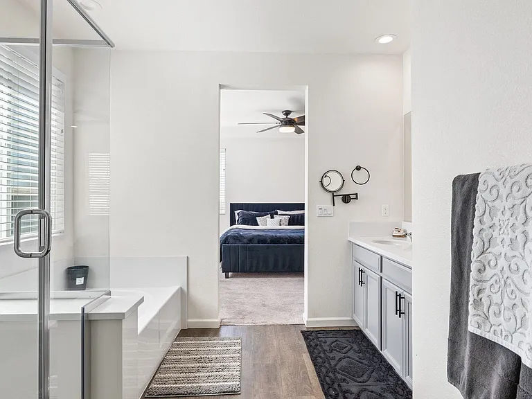 Upstairs, the oversized primary suite bathroom with soaking Tub and separate Shower