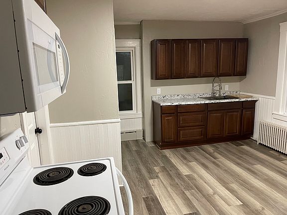 Kitchen includes microwave, stove and refrigerator.