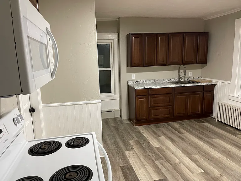 Kitchen includes microwave, stove and refrigerator.