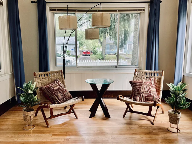 View of the sun room, which has three large windows.