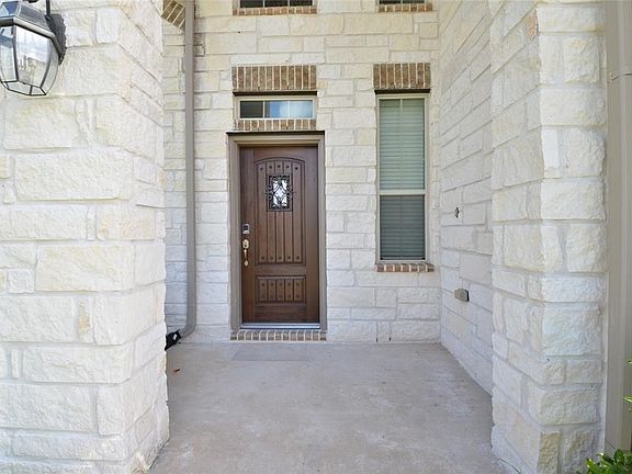 Front porch with beautiful front door with automatic lock box.